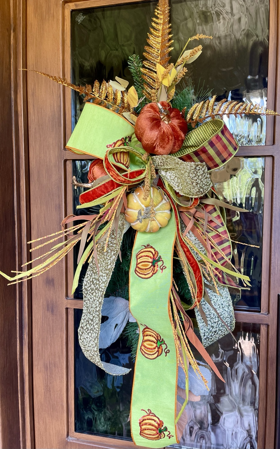 PRE-ORDER | Gilded Harvest Fall Door Swag — handcrafted fall door swag with velvet pumpkins, gold foliage, and layered designer ribbon in rust, burgundy, green, and gold