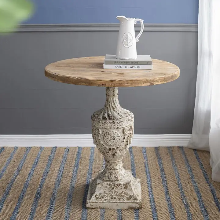 Maison Urn Pedestal Table styled with books and white pitcher